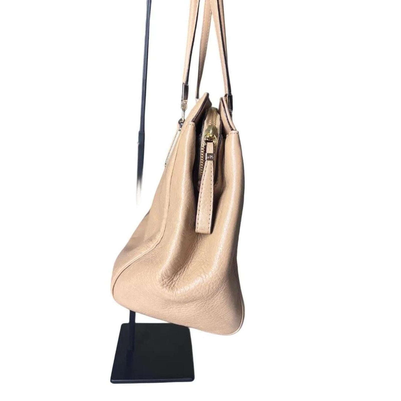 A stylish Coach Madison Kimberly Carryall Tote Bag in beige leather