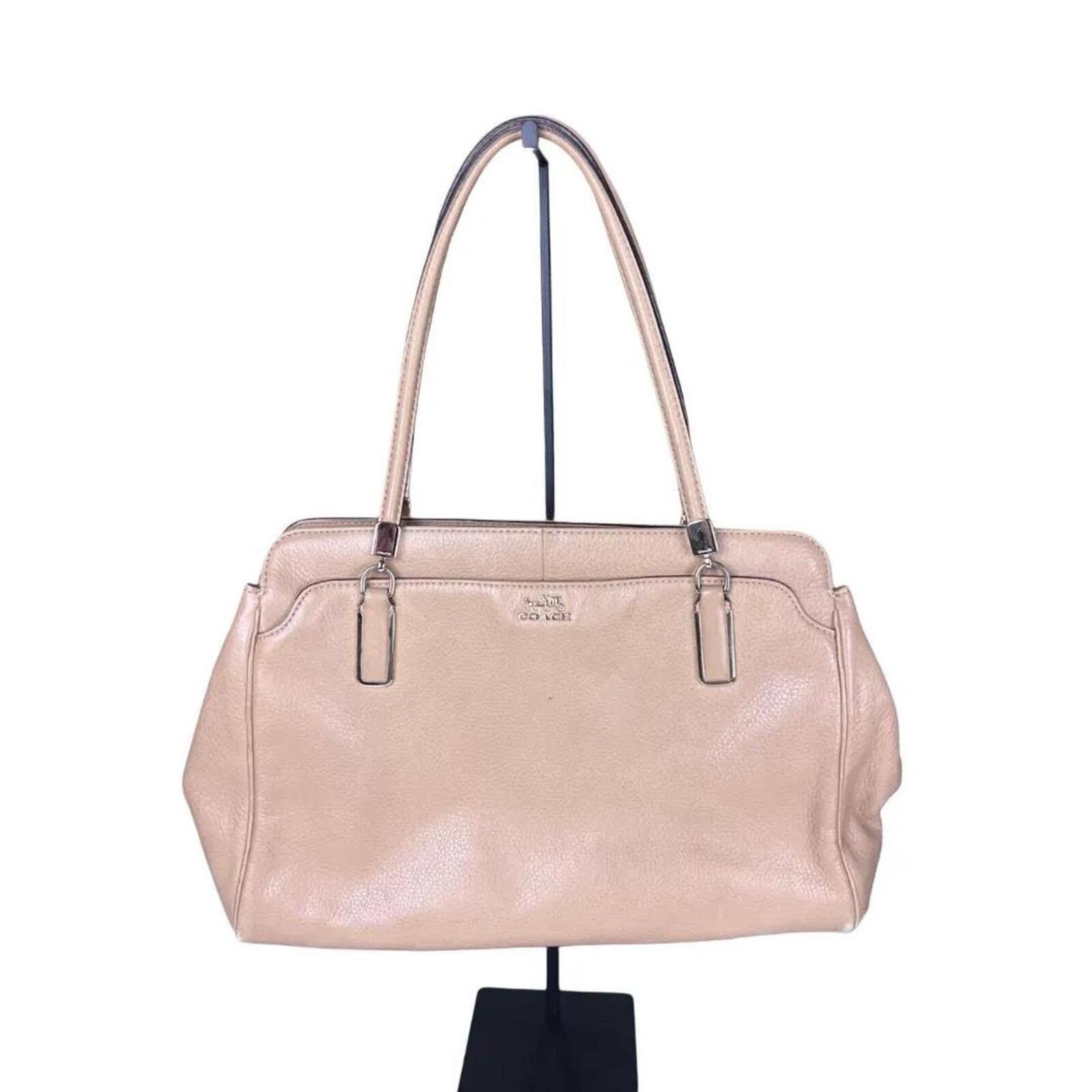 A stylish Coach Madison Kimberly Carryall Tote Bag in beige leather