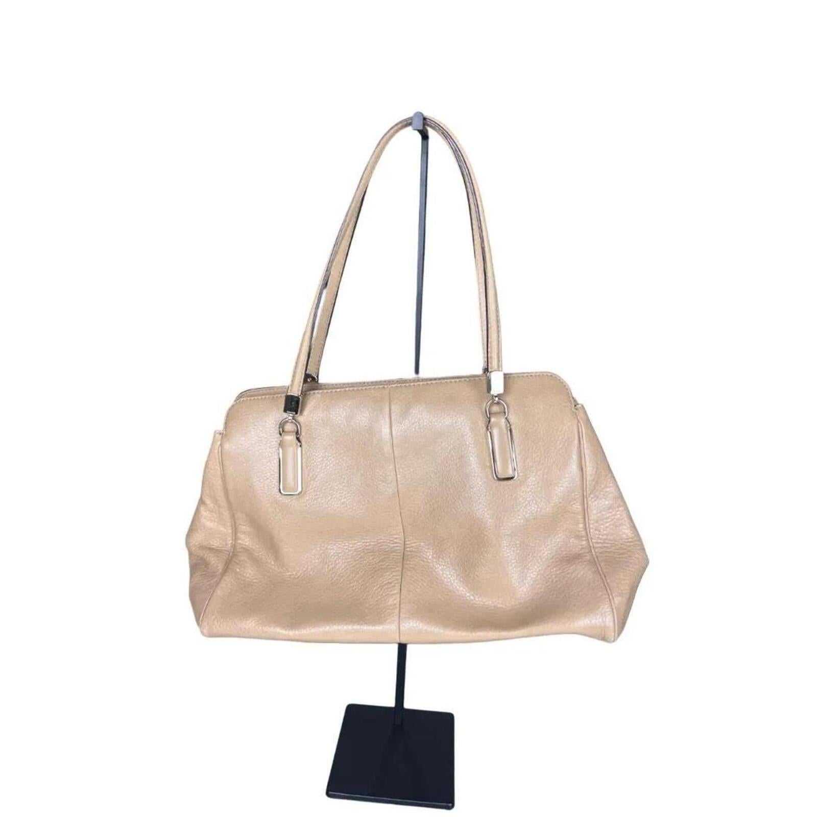 A stylish Coach Madison Kimberly Carryall Tote Bag in beige leather