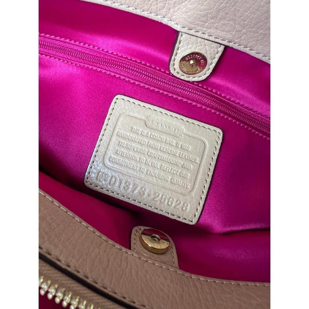A stylish Coach Madison Kimberly Carryall Tote Bag in beige leather