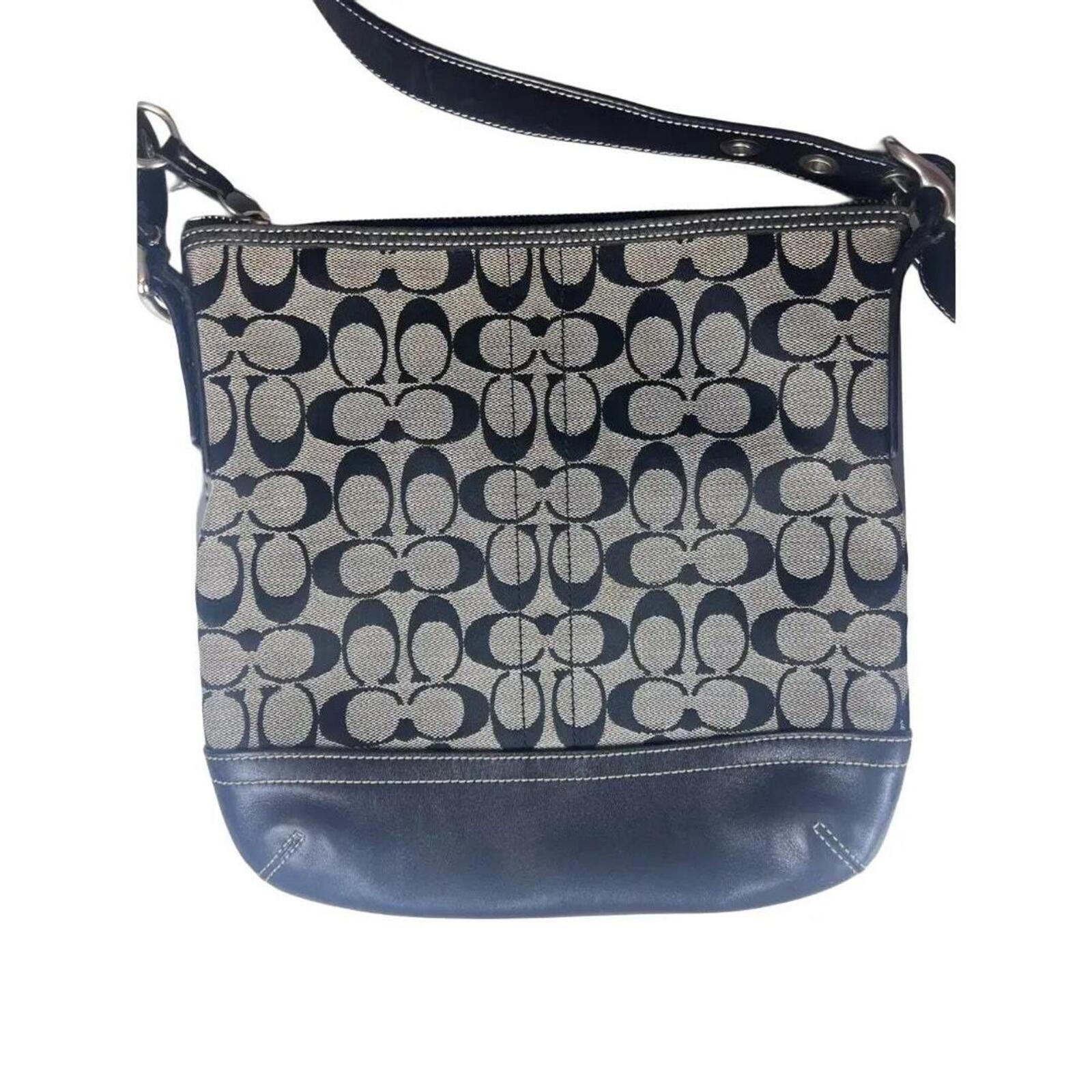 A classic Coach Signature Canvas Shoulder Bag in black and grey