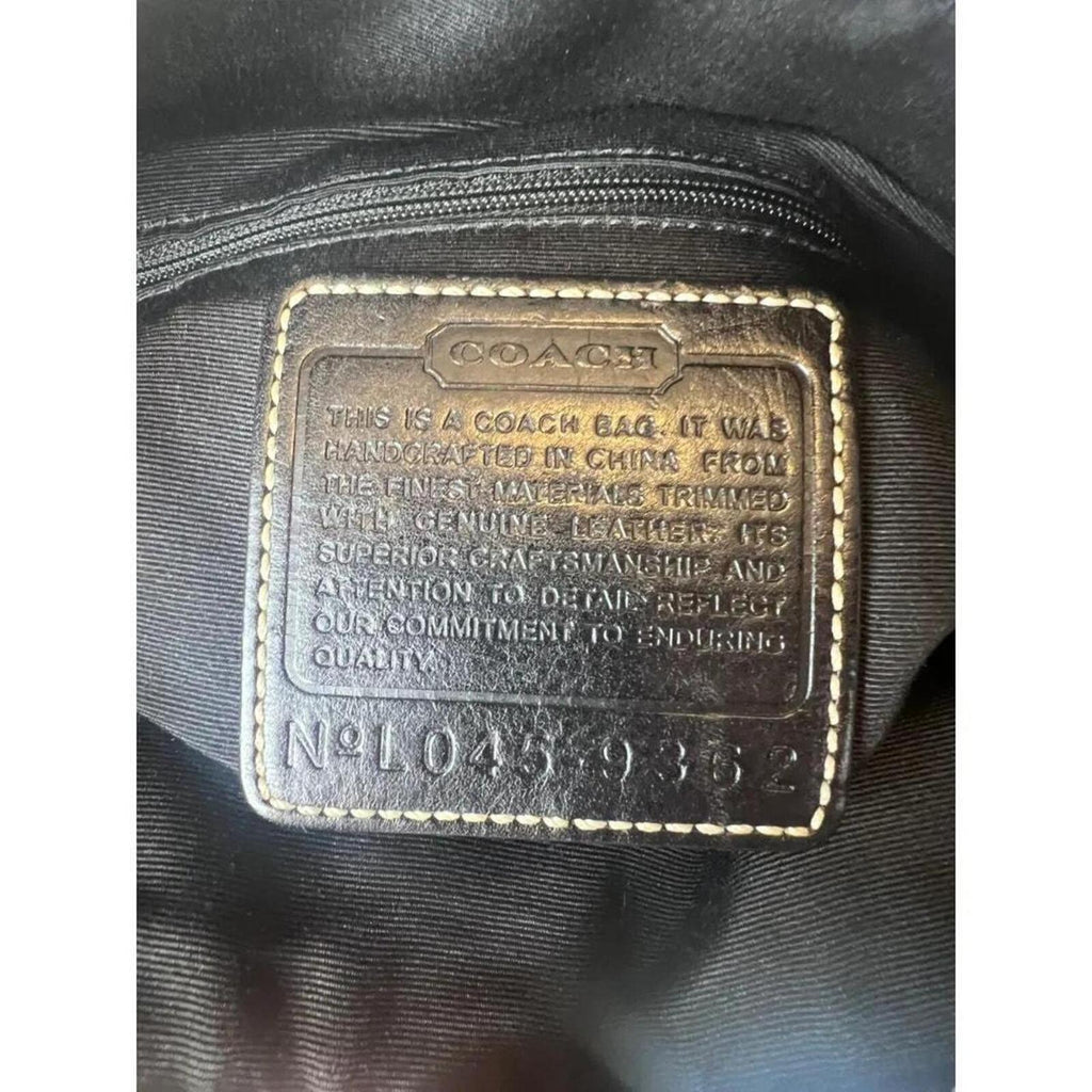 A classic Coach Signature Canvas Shoulder Bag in black and grey