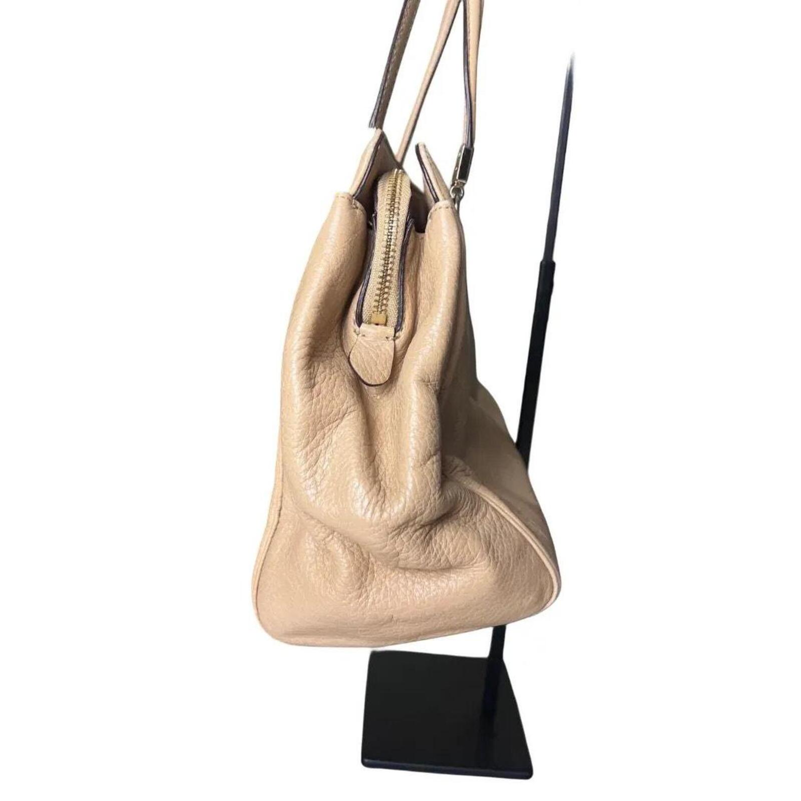 A stylish Coach Madison Kimberly Carryall Tote Bag in beige leather