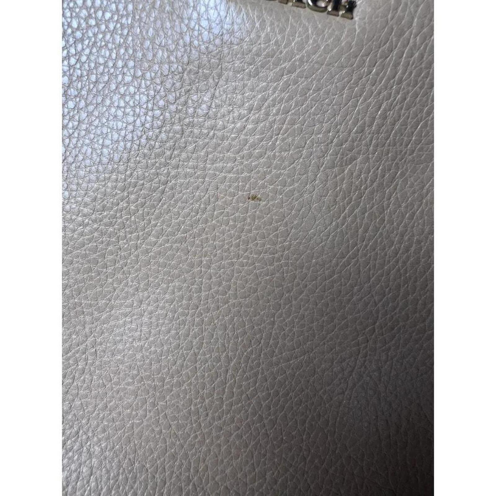 A stylish Coach Madison Kimberly Carryall Tote Bag in beige leather
