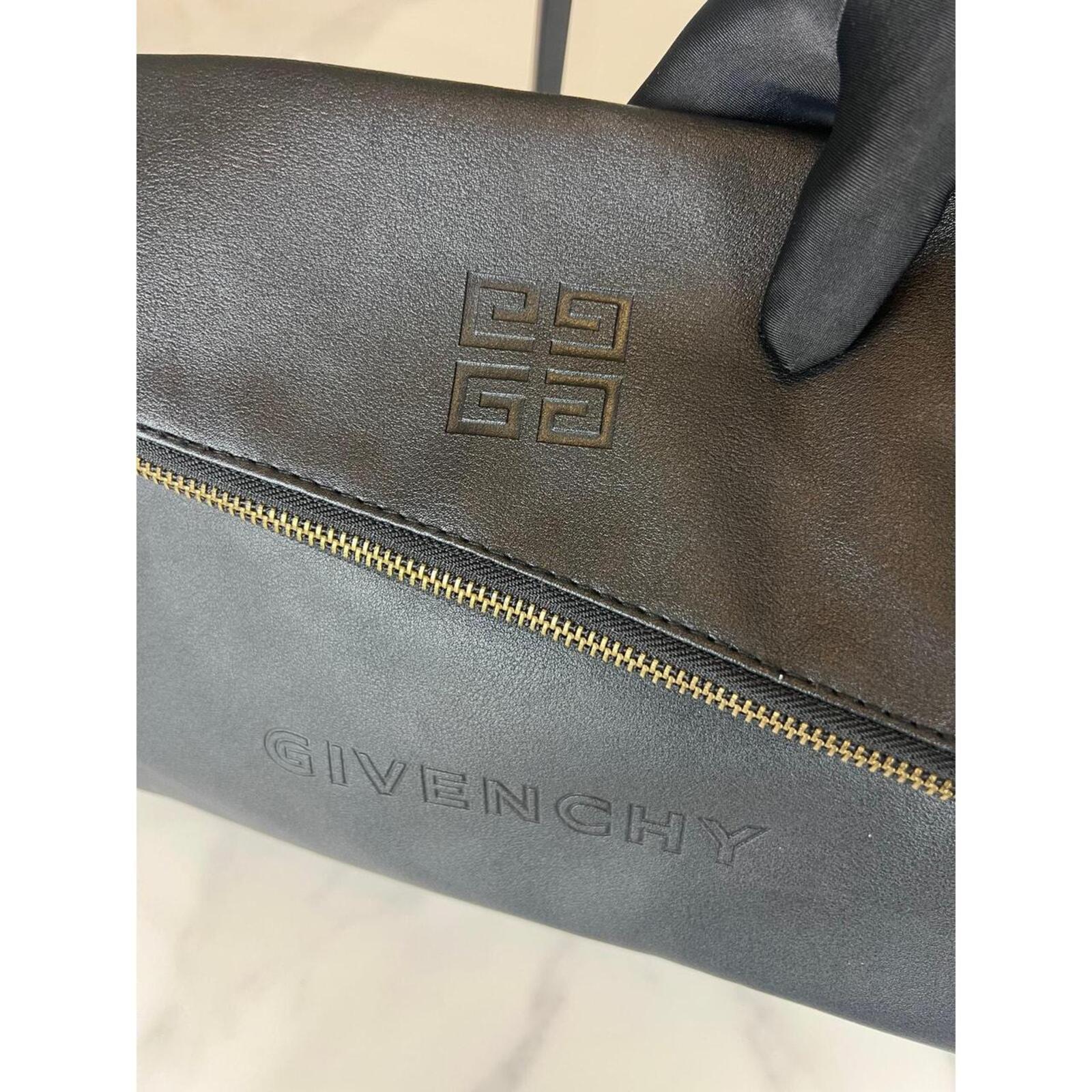 Givenchy black leather shoulder/clutch — sleek, minimalist designer bag in smooth black leather; versatile day-to-night elegance.