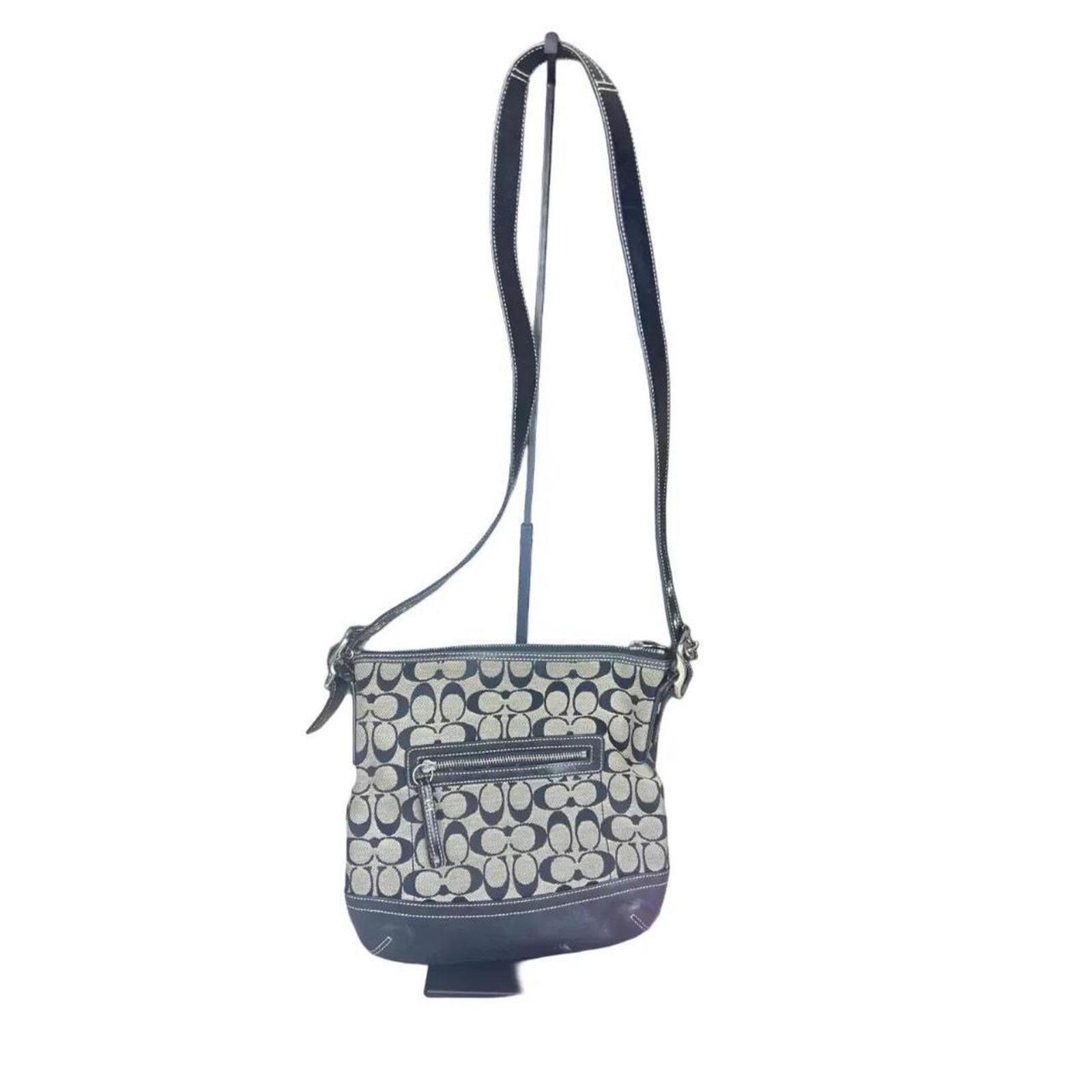A classic Coach Signature Canvas Shoulder Bag in black and grey